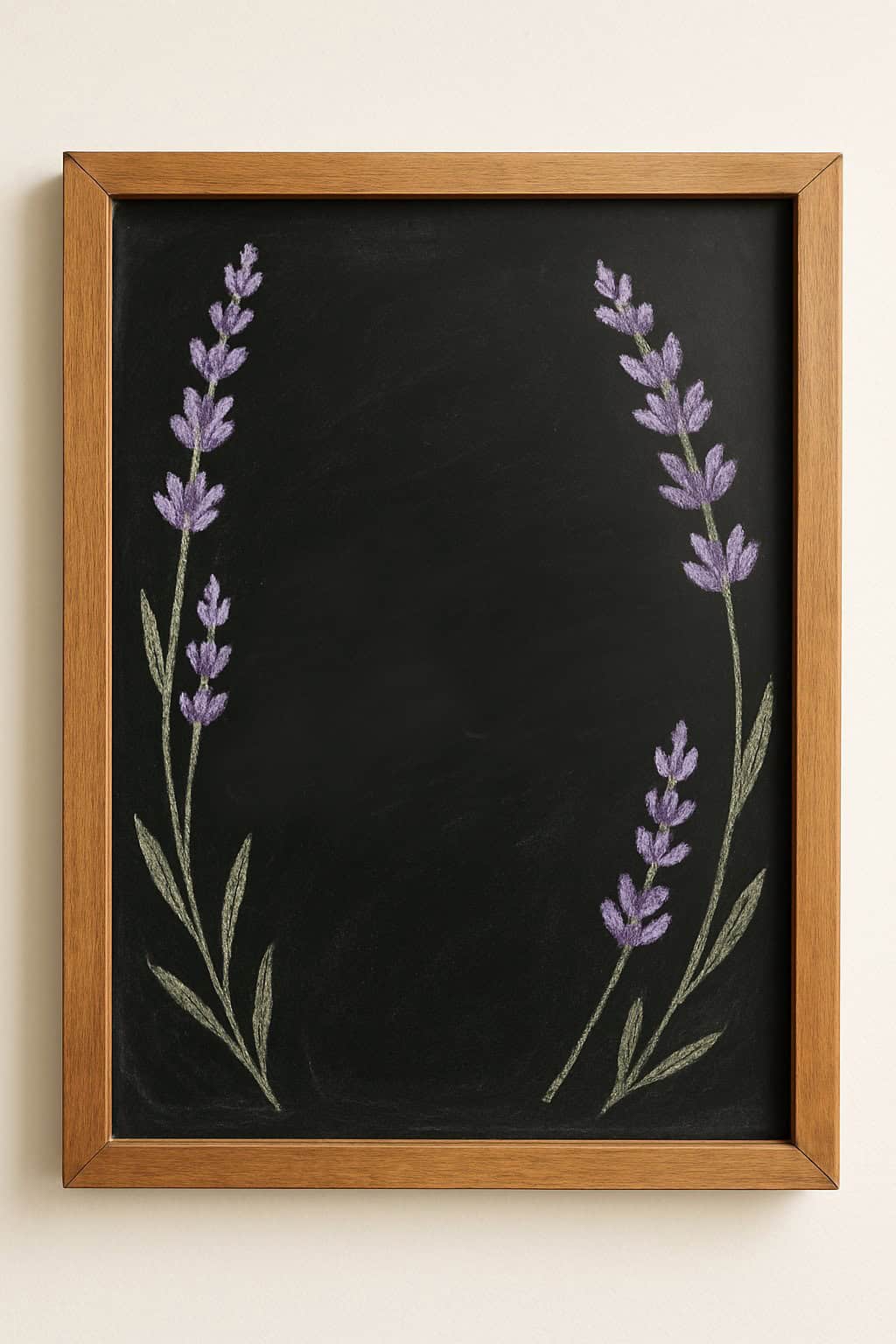 A black chalkboard with a wooden frame, decorated with light purple lavender flowers and green stems drawn in chalk on the left and right sides, leaving the center empty.