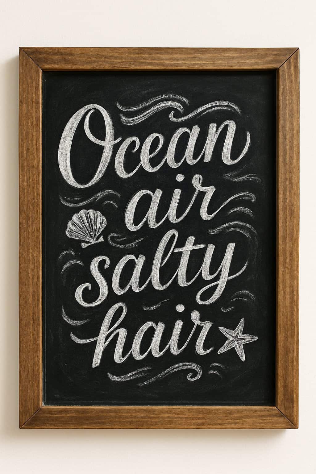A wooden framed chalkboard sign with artistic beach-themed decorations on a clean surface.