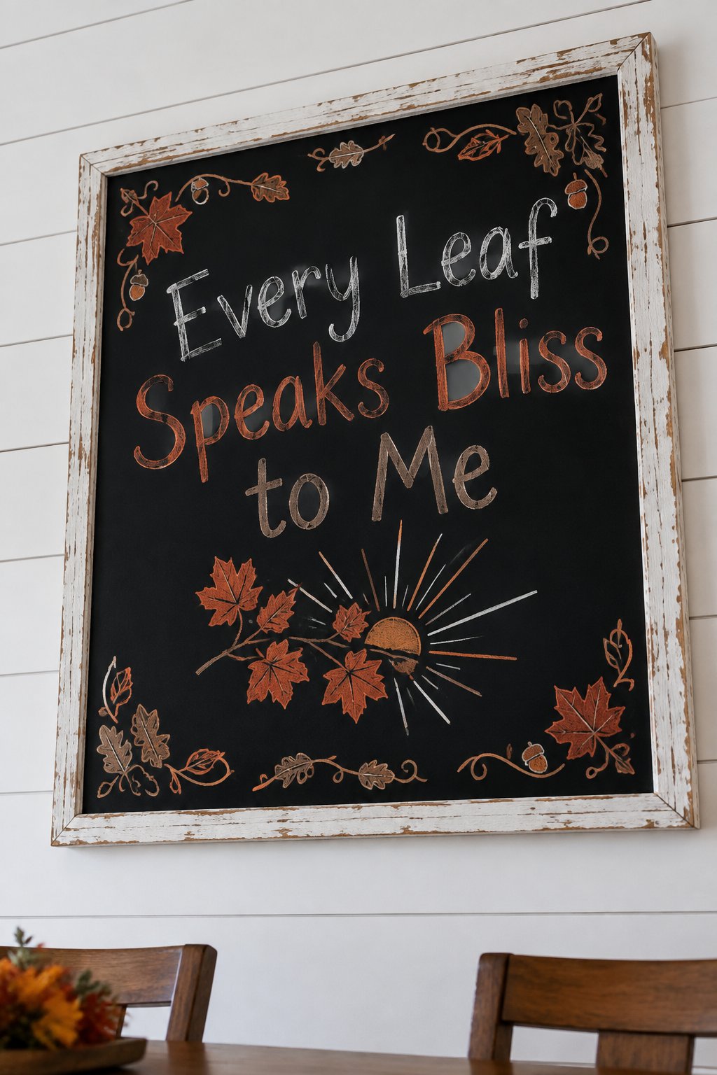 Golden Hour Leaves: a fall chalkboard sign reading "Every Leaf Speaks Bliss to Me", hand-drawn in chalk with sun rays breaking through a maple branch, no people.